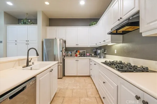 a kitchen with a sink stainless steel appliances and cabinets