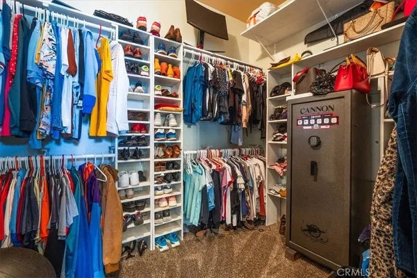 a view of walk in closet with clothes