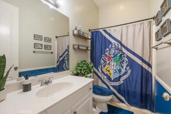 a bathroom with a sink a vanity and toilet