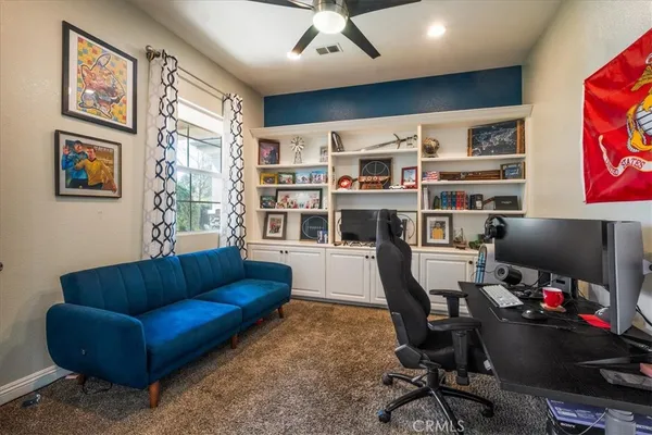 a living room with furniture workspace and a flat screen tv