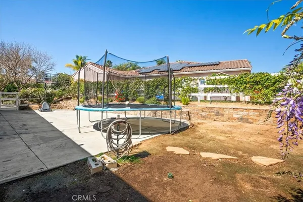 an aerial view of residential houses with outdoor space and street view