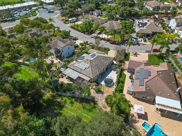 an aerial view of a house with a yard and lake view