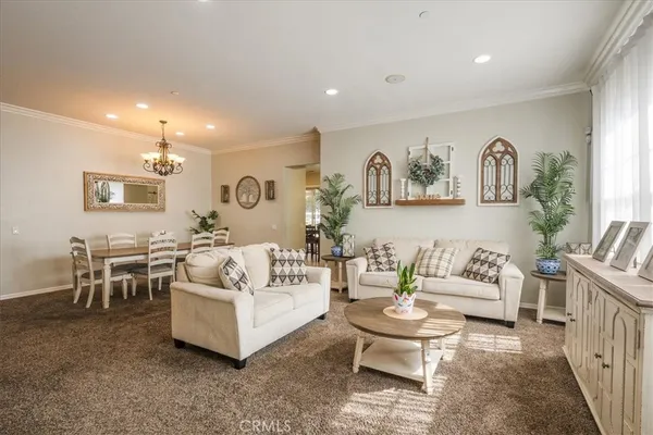 a living room with furniture and painting on the wall