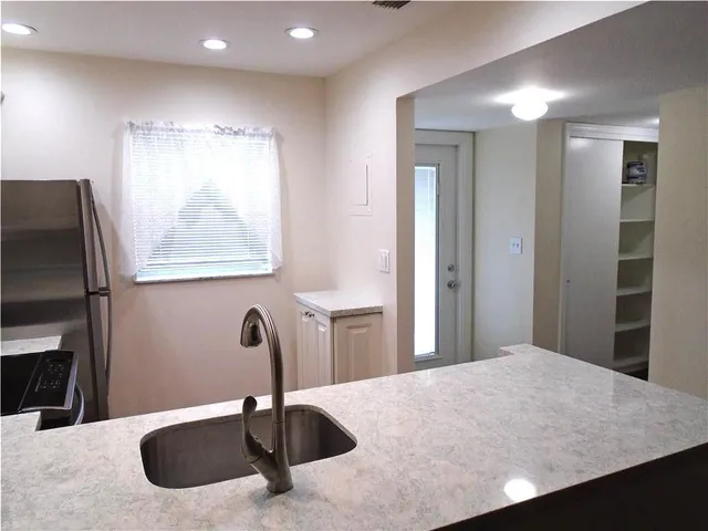 a bathroom with a sink a light fixture and a mirror