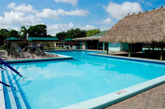 a view of swimming pool with seating area and furniture