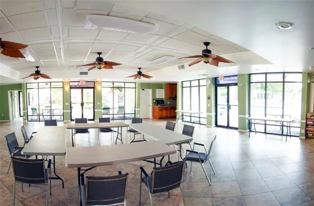 a view of a livingroom with furniture window and a kitchen