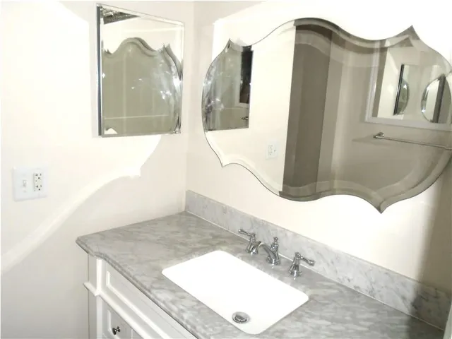 a bathroom with a sink and mirror
