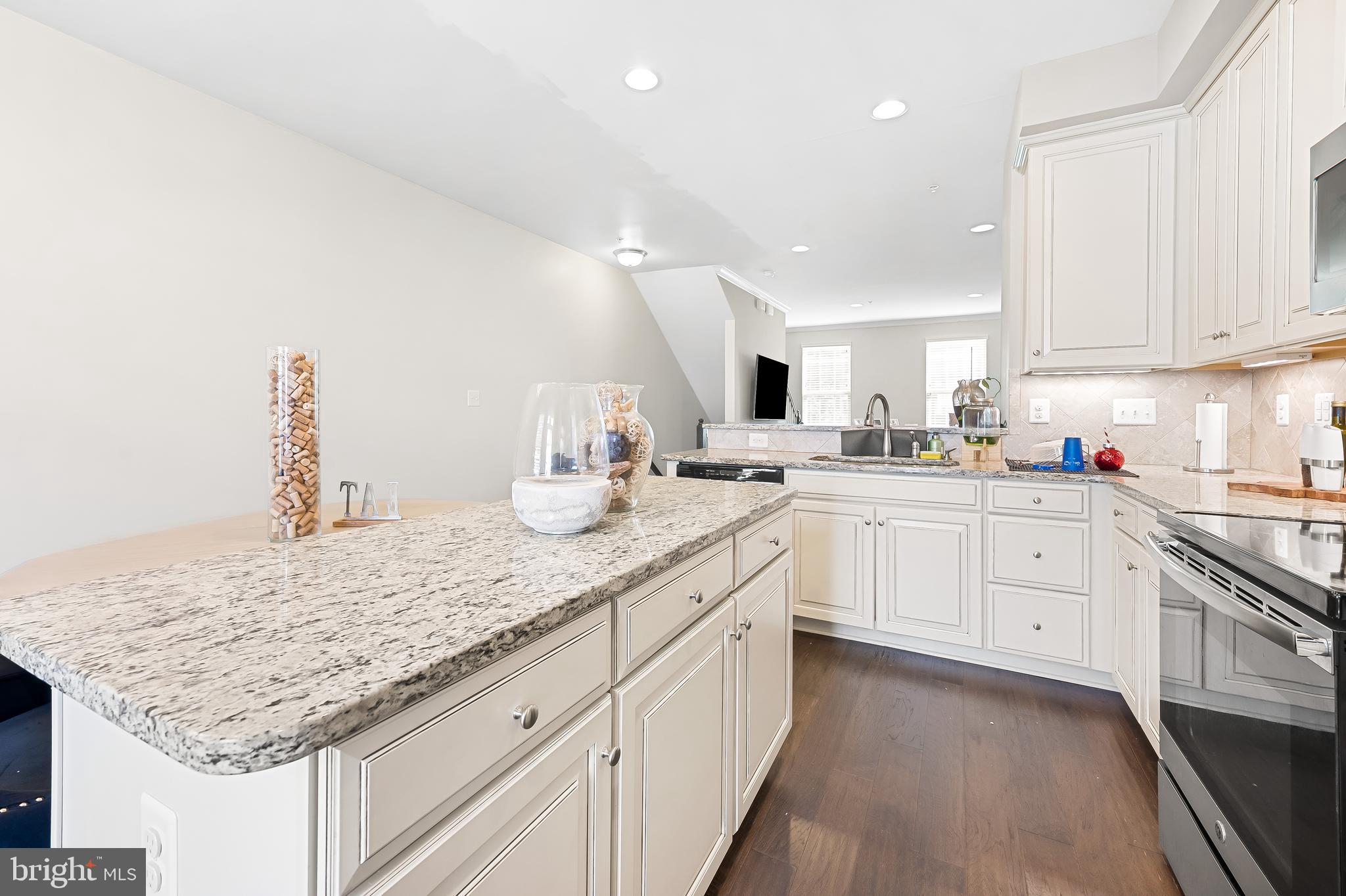 810 South Macon Street Baltimore, MD 21224 - Photo 6 of 31 a kitchen with granite countertop white cabinets and white appliances
