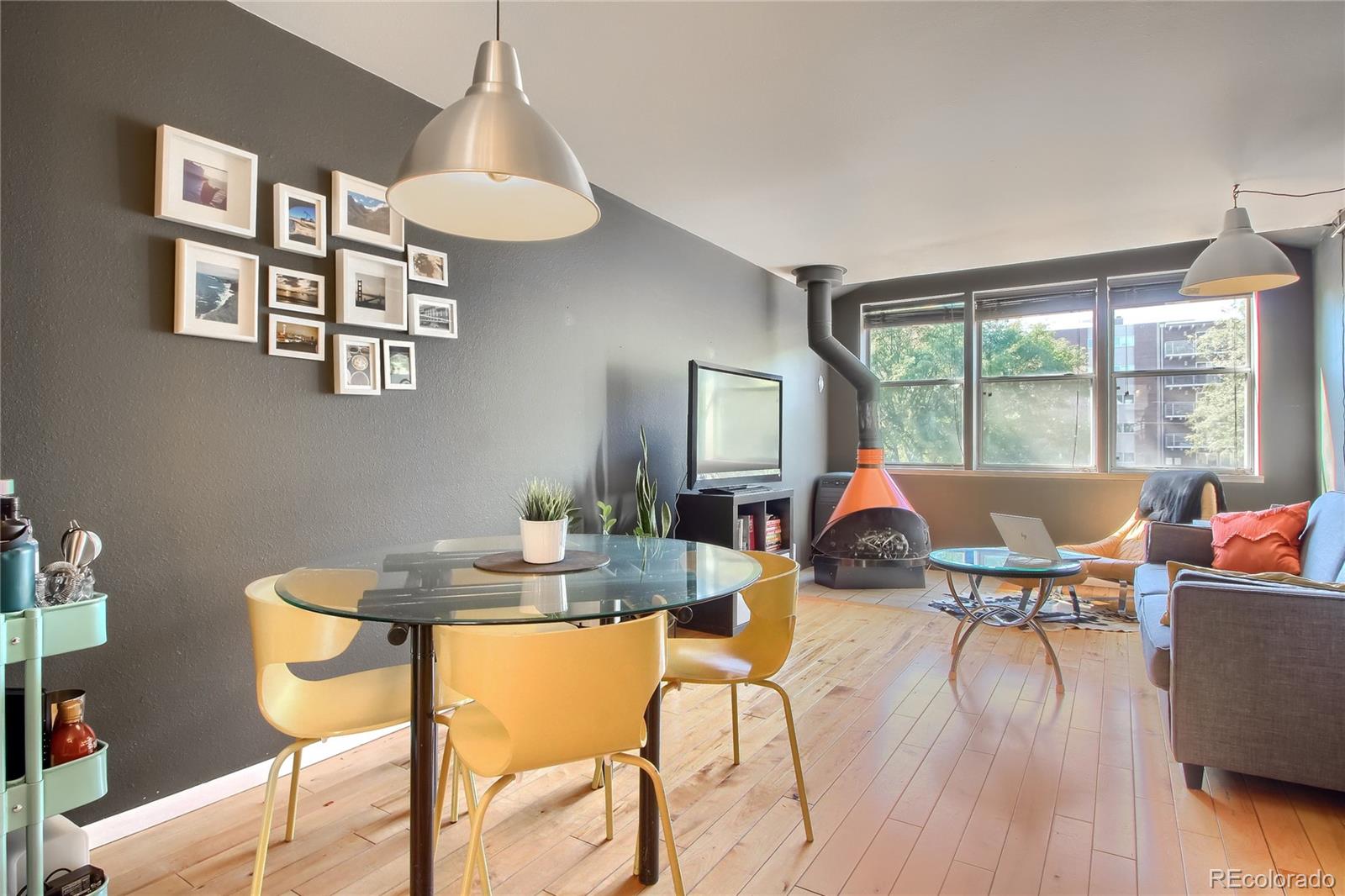 1300 Garfield Street, Unit 2 Denver, CO 80206 - Photo 13 of 34 a view of a dining room with furniture wooden floor and chandelier