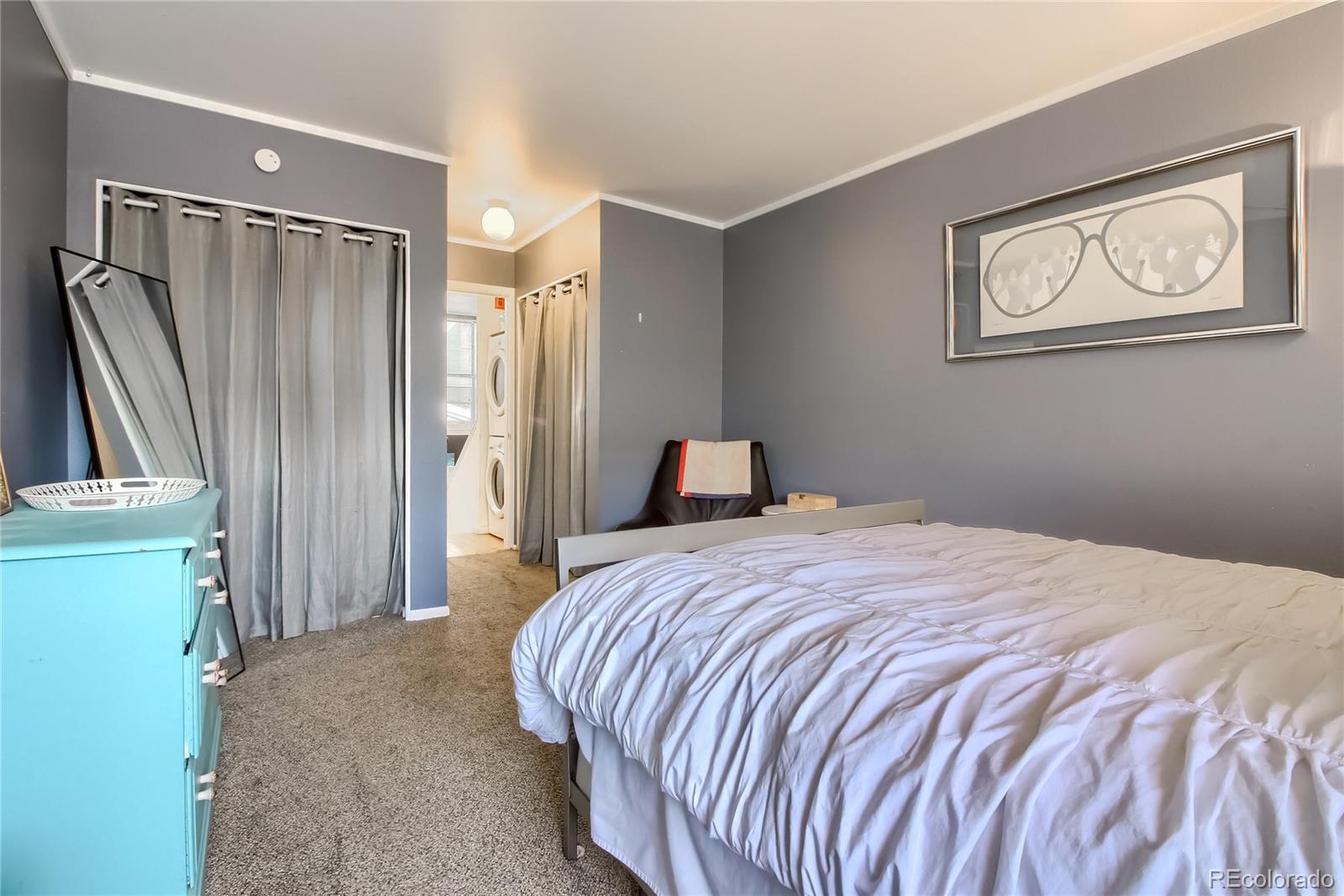 1300 Garfield Street, Unit 2 Denver, CO 80206 - Photo 18 of 34 a bedroom with a bed and a refrigerator