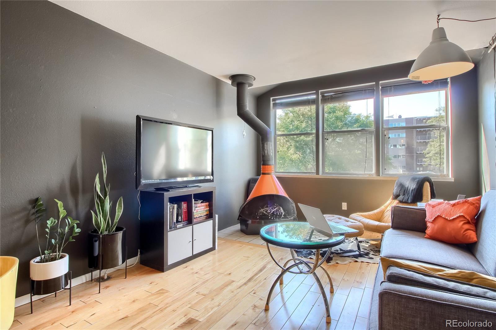 1300 Garfield Street, Unit 2 Denver, CO 80206 - Photo 2 of 34 a living room with furniture a window and a flat screen tv