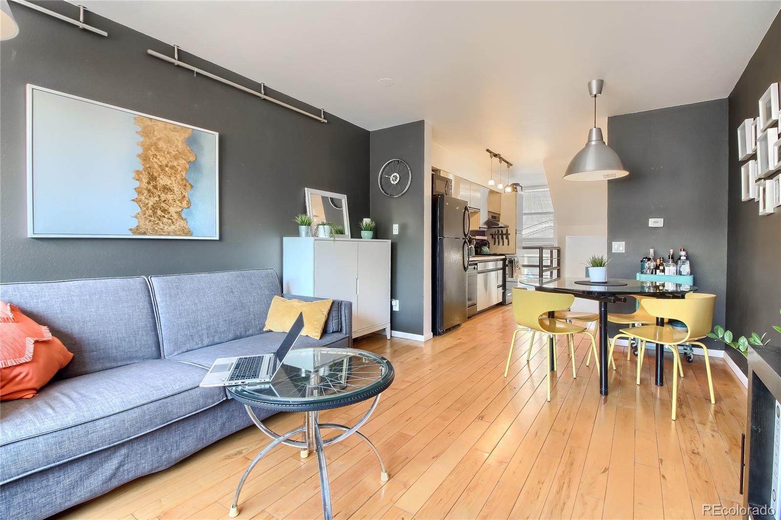 1300 Garfield Street, Unit 2 Denver, CO 80206 - Photo 4 of 34 a living room with furniture and a dining table with wooden floor