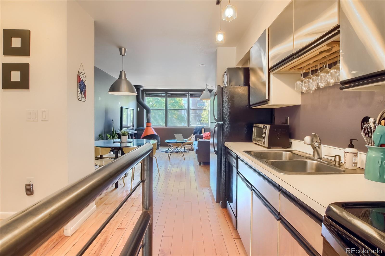 1300 Garfield Street, Unit 2 Denver, CO 80206 - Photo 7 of 34 a kitchen with stainless steel appliances granite countertop sink stove and cabinets