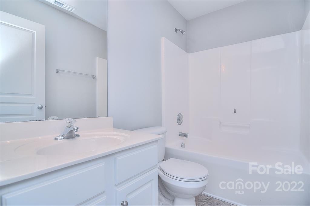 616 Brickdust Court Fort Mill, SC 29708 - Photo 29 of 38 a bathroom with a sink a toilet and a large mirror