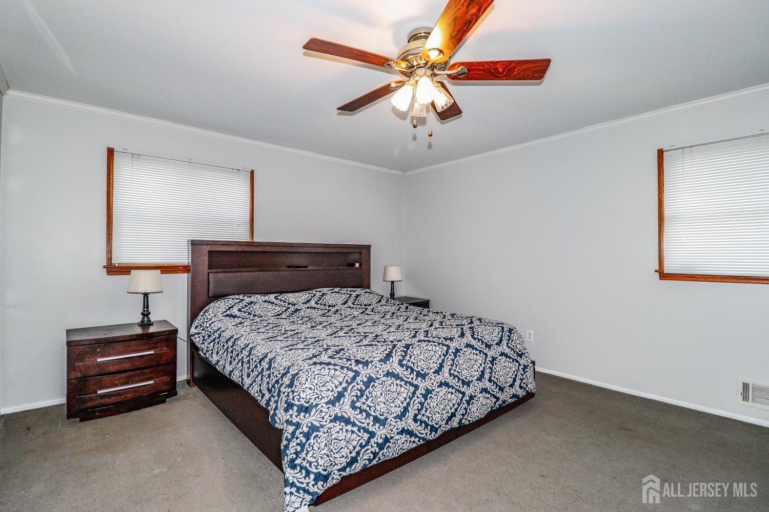 5 Timothy Court Edison, NJ 08837 - Photo 15 of 32 a bedroom with a bed and a chandelier