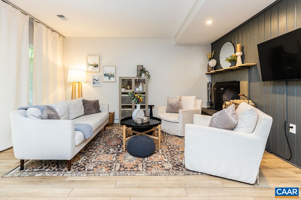 449 3 Ridges Wintergreen, VA 22967 - Photo 2 of 21 a living room with furniture a flat screen tv and a fireplace