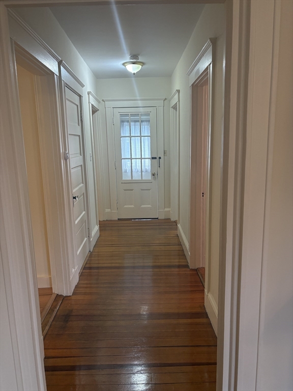 97 Warwick Road, Unit 97 Newton, MA 02465 - Photo 11 of 24 a view of a hallway with wooden floor and staircase