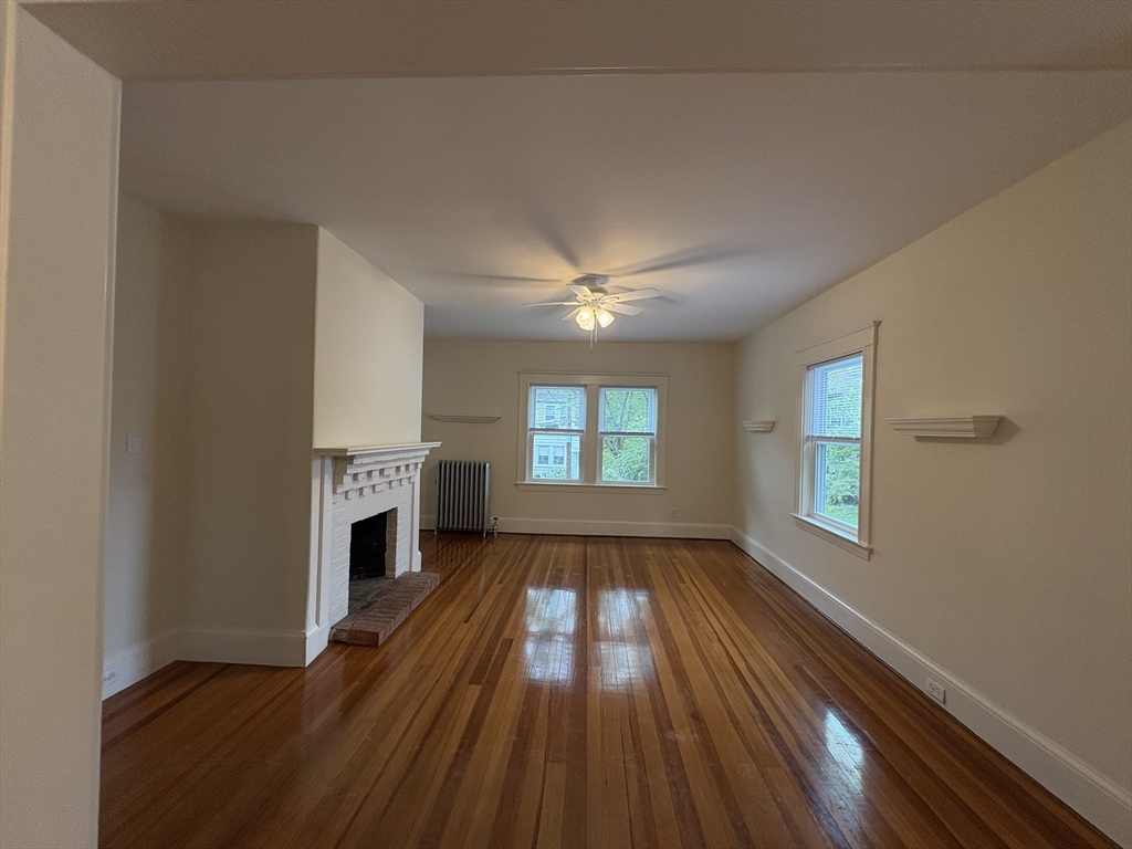 97 Warwick Road, Unit 97 Newton, MA 02465 - Photo 18 of 24 wooden floor in an empty room with a window
