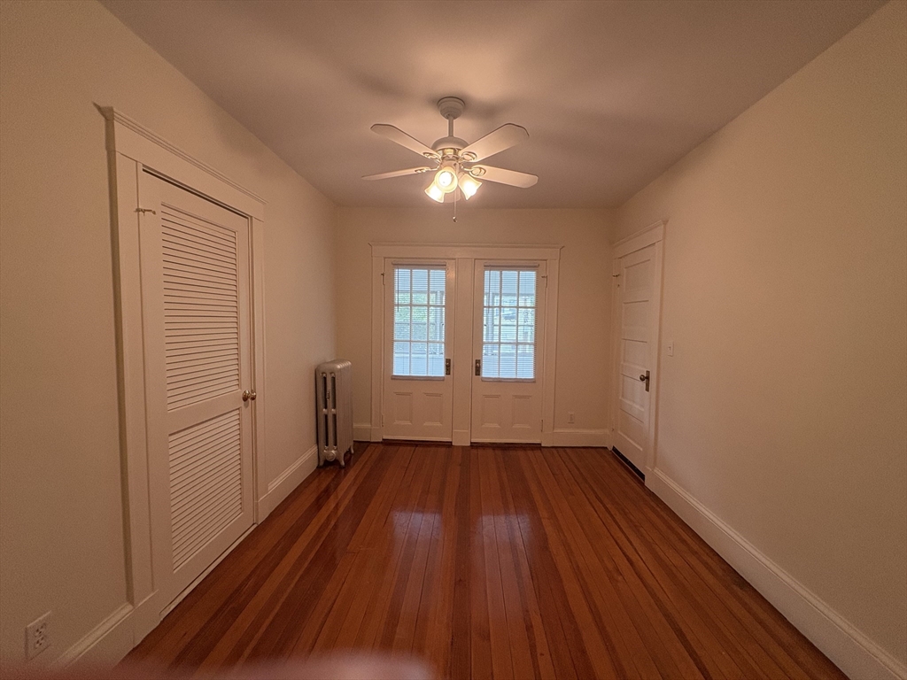 97 Warwick Road, Unit 97 Newton, MA 02465 - Photo 23 of 24 a view of empty room with wooden floor and fan