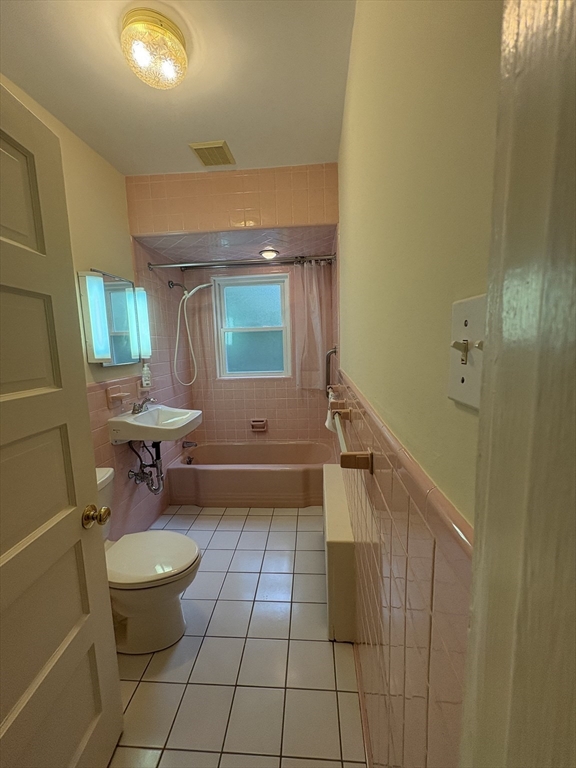 97 Warwick Road, Unit 97 Newton, MA 02465 - Photo 6 of 24 a bathroom with a sink a toilet and shower