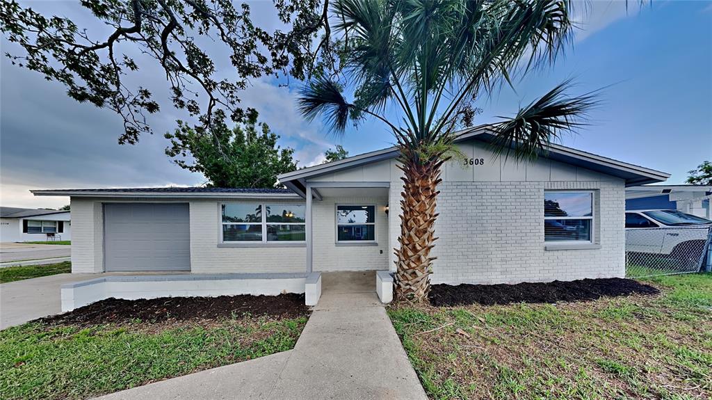3608 Chauncy Road Holiday, FL 34691 - Photo 1 of 1 a house that has a tree in front of the house