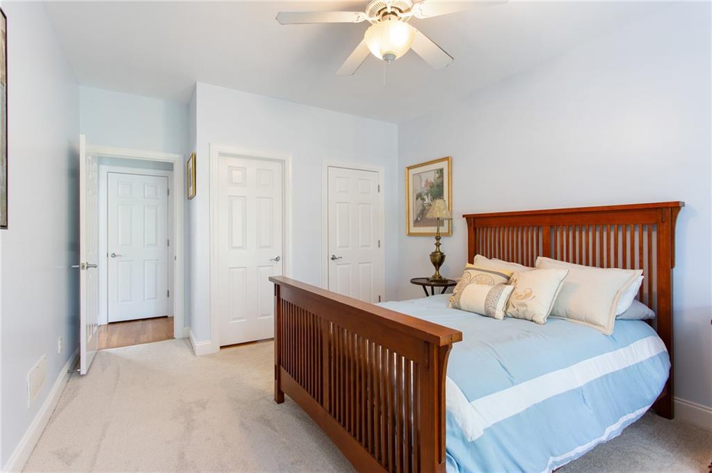 3522 Ivy Manor Road Southeast Smyrna, GA 30080 - Photo 12 of 47 a bedroom with a bed and a chandelier