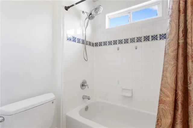 a bathroom with a shower a toilet and sink