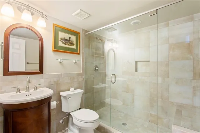 a bathroom with a sink toilet and shower