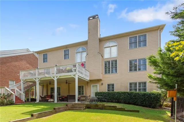 a front view of a house with swimming pool and porch with furniture