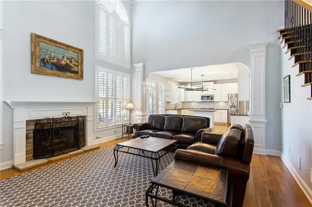 a living room with furniture a fireplace and a large window