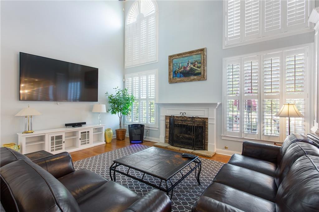 3522 Ivy Manor Road Southeast Smyrna, GA 30080 - Photo 6 of 47 a living room with furniture a flat screen tv and a fireplace