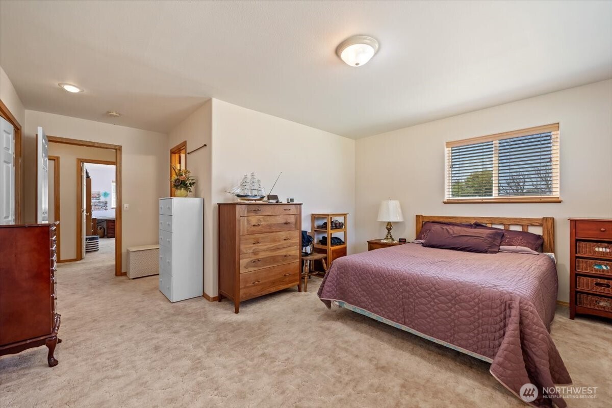 157209 West North River Road Prosser, WA 99350 - Photo 25 of 40 a bedroom with a bed and a chandelier