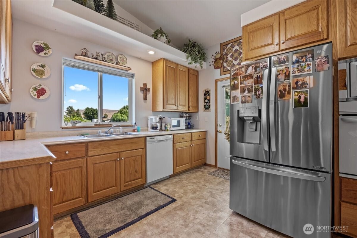 157209 West North River Road Prosser, WA 99350 - Photo 8 of 40 a kitchen with stainless steel appliances a refrigerator sink and cabinets