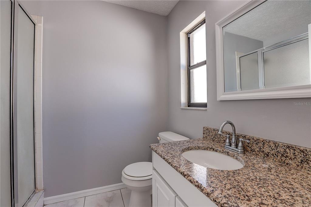 1418 Buckner Road Valrico, FL 33596 - Photo 27 of 37 a bathroom with a granite countertop sink and a mirror