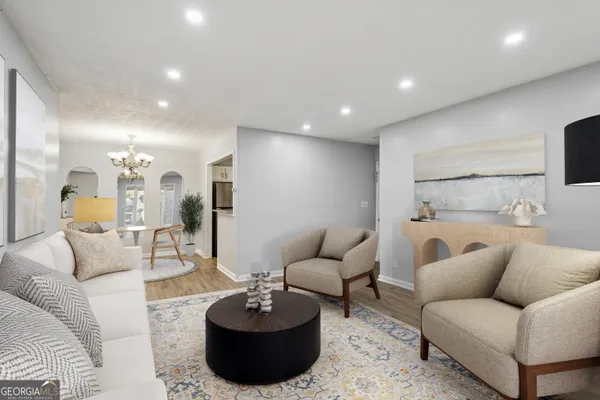 a living room with furniture and a wooden floor