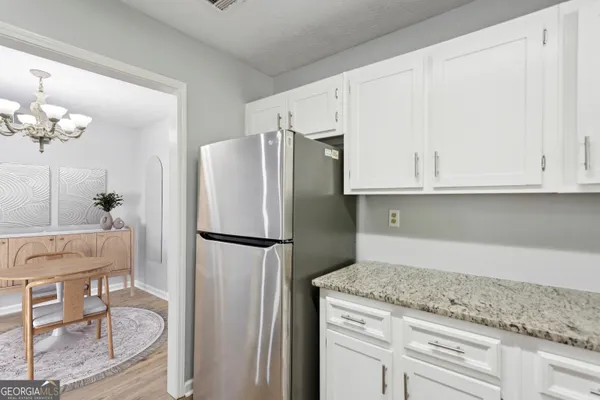 a kitchen with stainless steel appliances granite countertop a refrigerator sink and cabinets