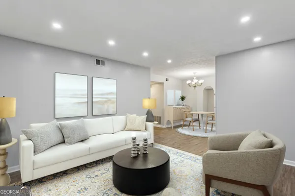 a living room with furniture and a mirror