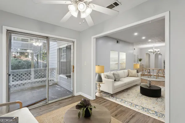 a living room with furniture and a glass door