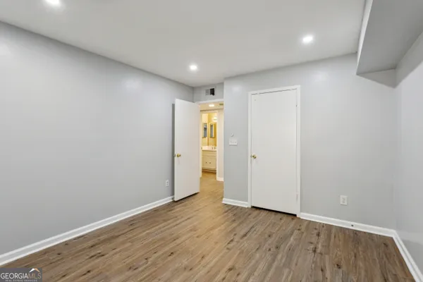 a view of an empty room with wooden floor