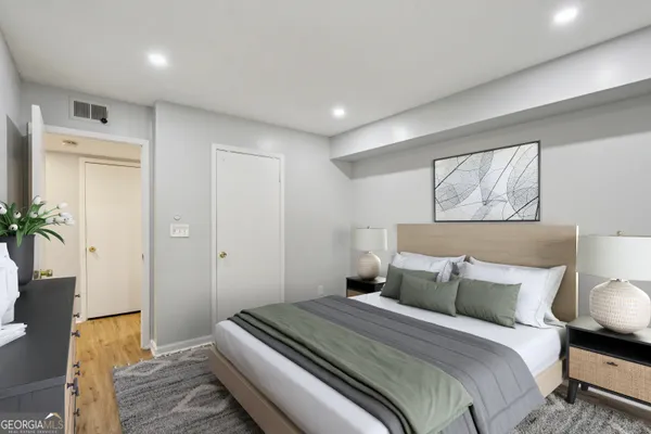 a bedroom with a bed and a potted plant