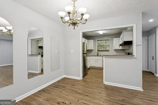 a view of a kitchen with a sink wooden cabinet and a living room