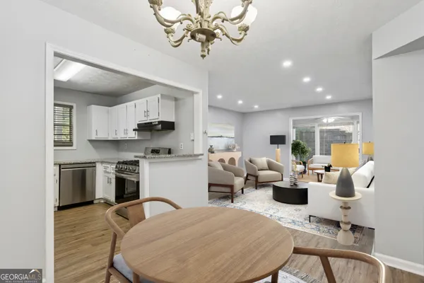 a living room with stainless steel appliances kitchen island granite countertop furniture and a kitchen view
