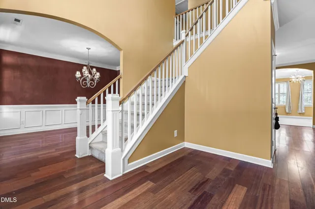 a front view of a house with wooden floor and a large window