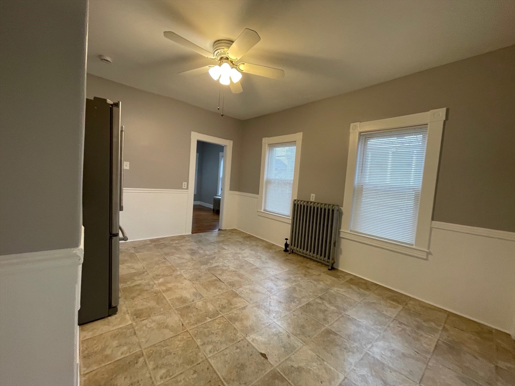 46 Lane Street, Unit 1 Lowell, MA 01851 - Photo 11 of 19 an empty room with windows and fan