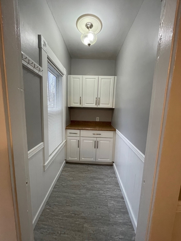 46 Lane Street, Unit 1 Lowell, MA 01851 - Photo 12 of 19 a kitchen with white cabinets and white appliances