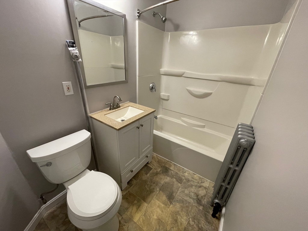 46 Lane Street, Unit 1 Lowell, MA 01851 - Photo 15 of 19 a bathroom with a sink toilet and shower