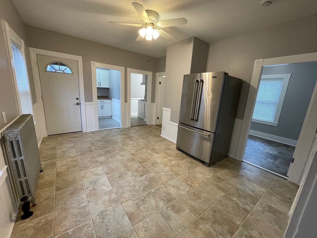 46 Lane Street, Unit 1 Lowell, MA 01851 - Photo 16 of 19 a view of a kitchen with refrigerator and wooden floor
