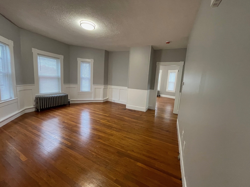 46 Lane Street, Unit 1 Lowell, MA 01851 - Photo 17 of 19 a view of empty room with wooden floor and fan
