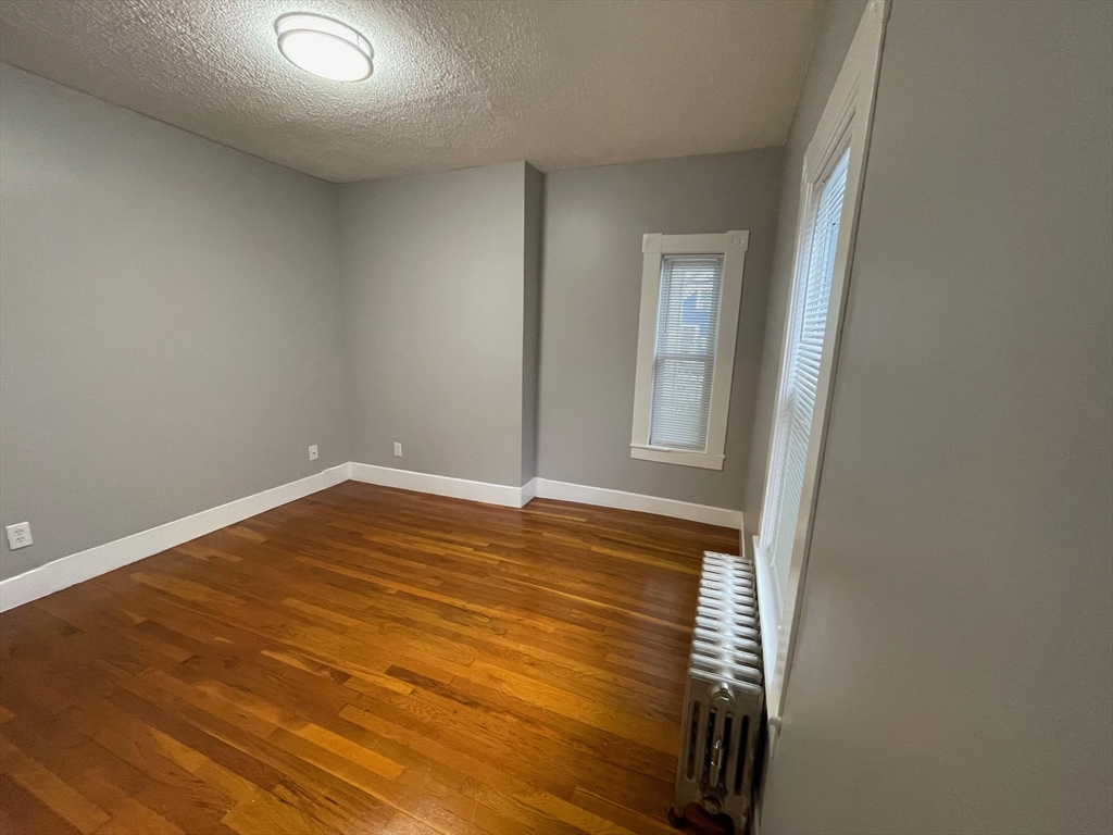 46 Lane Street, Unit 1 Lowell, MA 01851 - Photo 8 of 19 a view of empty room with wooden floor