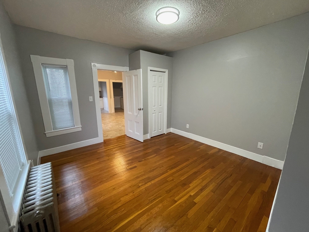 46 Lane Street, Unit 1 Lowell, MA 01851 - Photo 9 of 19 a view of empty room with wooden floor and fan